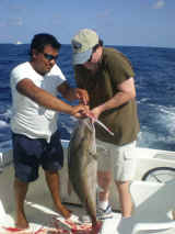 helping fishing crew- charter fishing cancun